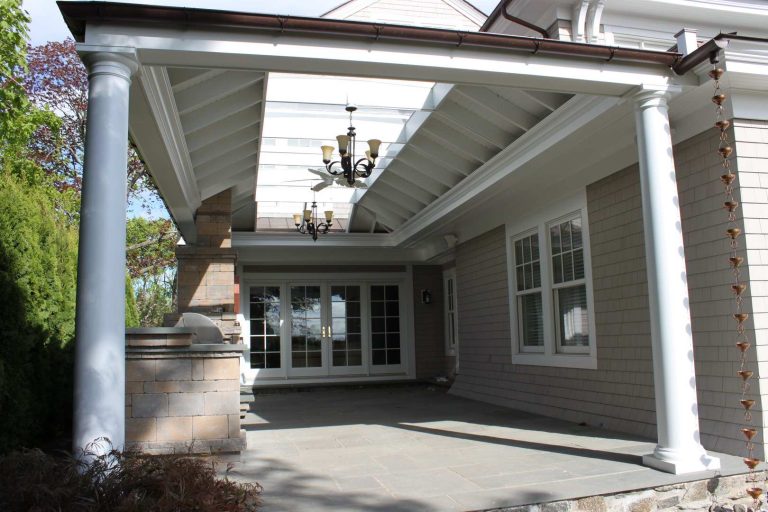 Inspiration for a timeless backyard stone patio kitchen remodel in New York with a roof extension