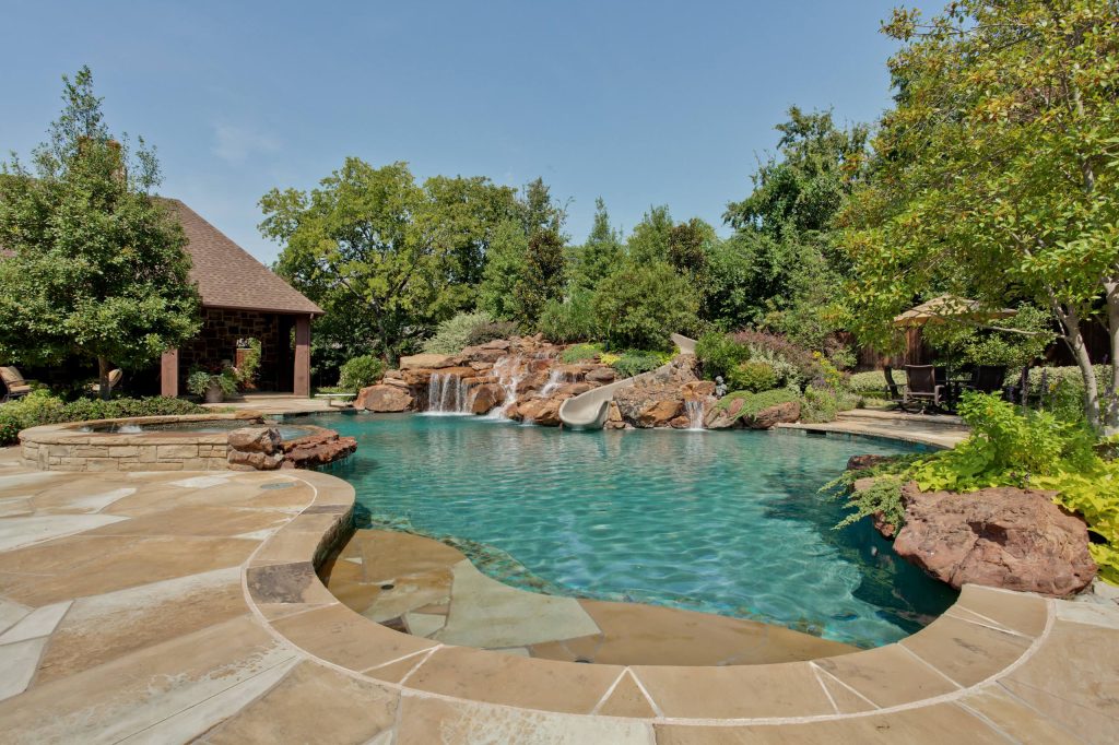 Inspiration for a timeless custom-shaped natural water slide remodel in Dallas