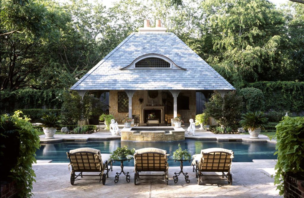 Inspiration for a timeless custom-shaped pool house remodel in Dallas