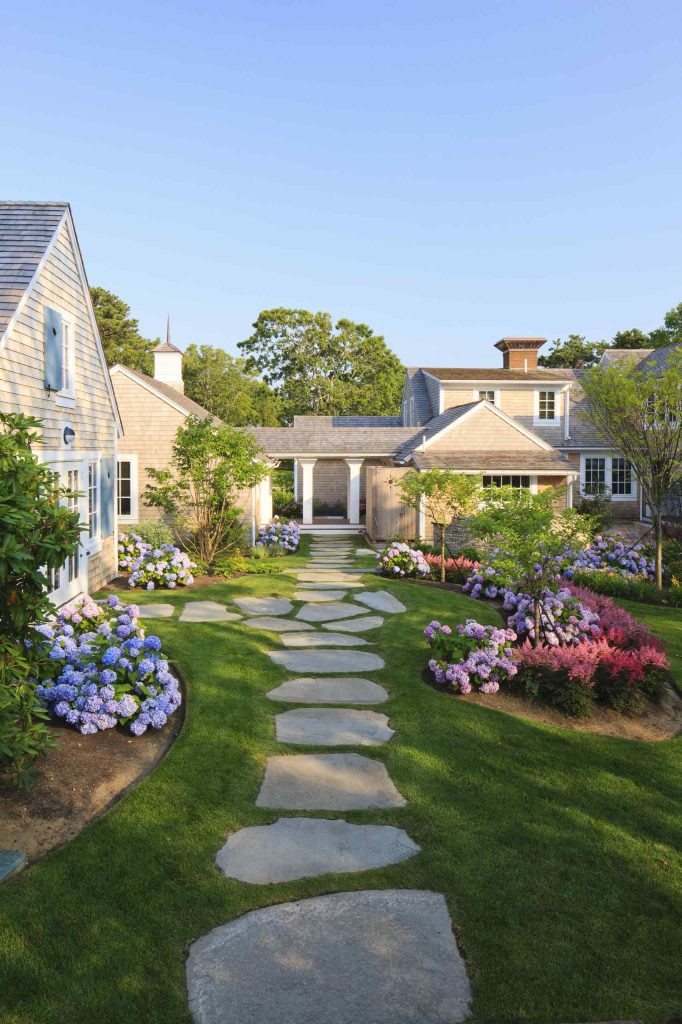 Inspiration for a traditional shade backyard stone landscaping in Boston.