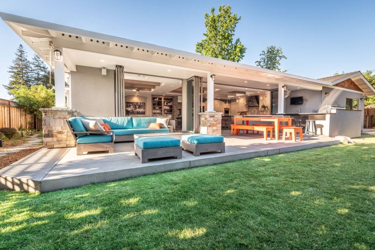 Inspiration for a transitional backyard concrete patio kitchen remodel in San Francisco with a roof extension