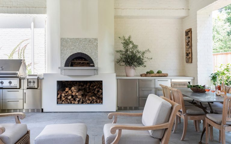 Inspiration for a transitional backyard stone patio kitchen remodel in Houston with a gazebo