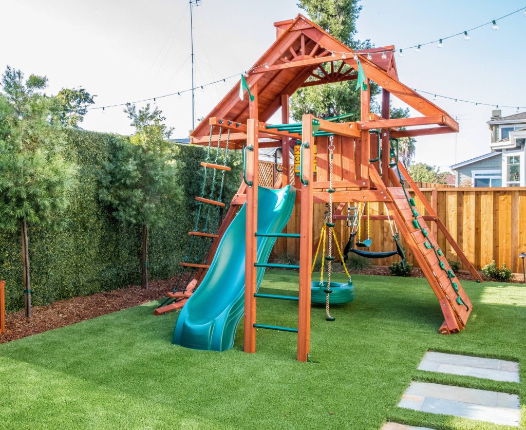 Inspiration for a transitional backyard wood fence outdoor playset in Richmond.