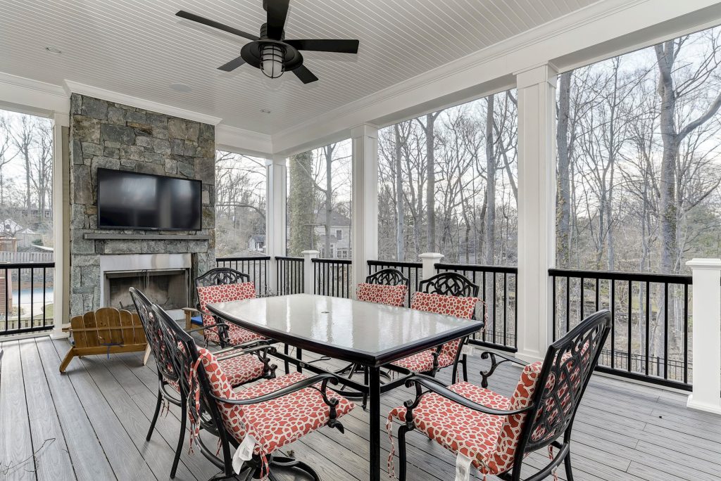 Inspiration for a transitional metal railing porch remodel in DC Metro with a fireplace, decking and a roof extension by Park Bradley Homes | Outdoor Photos | Porch | Landscaping | Landscape Design | Outdoor Living Space | Porch Design Ideas | Outdoor Living Space Ideas | Backyard Design