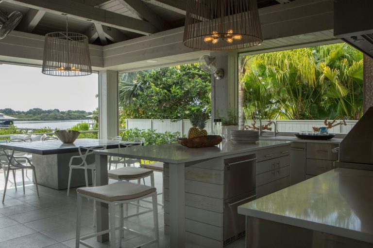 Inspiration for a transitional outdoor kitchen deck remodel in Orlando with a roof extension