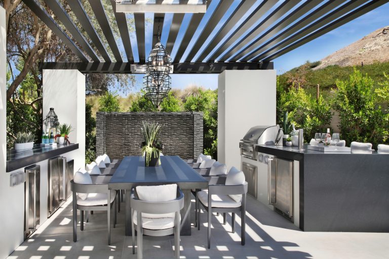 Inspiration for a transitional patio kitchen remodel in Orange County with a pergola