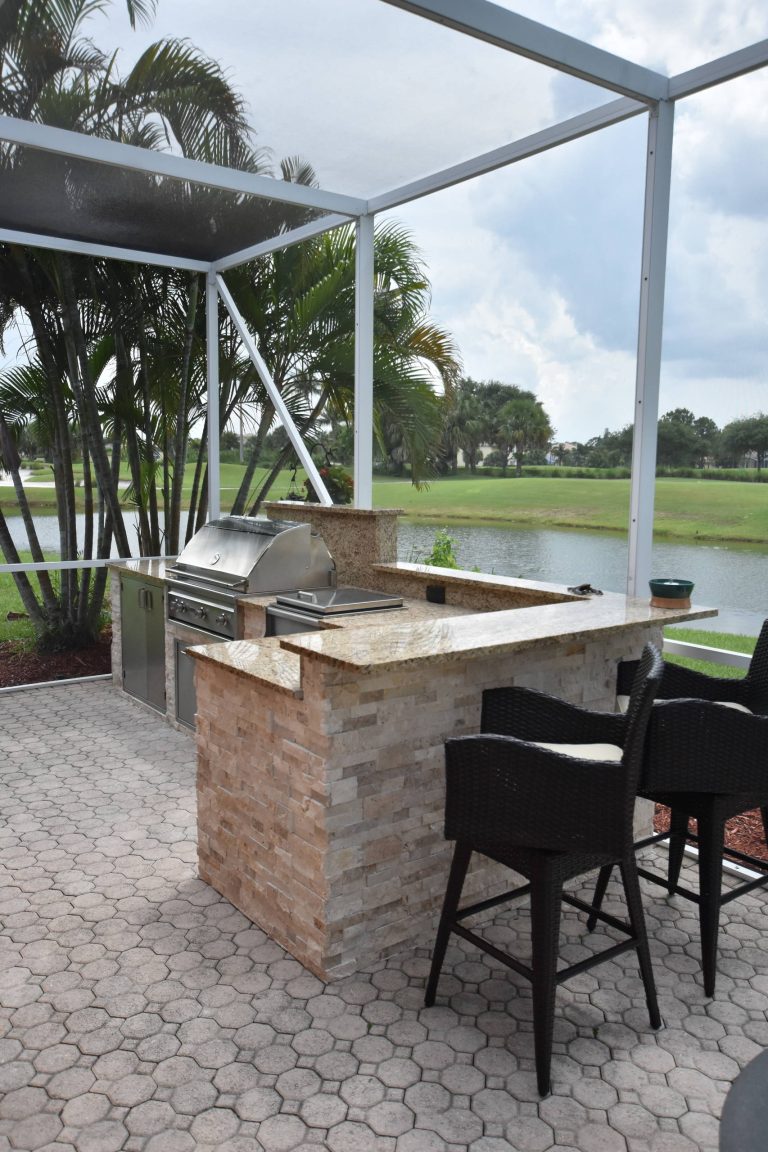 Inspiration for a tropical backyard brick patio kitchen remodel in Miami with no cover