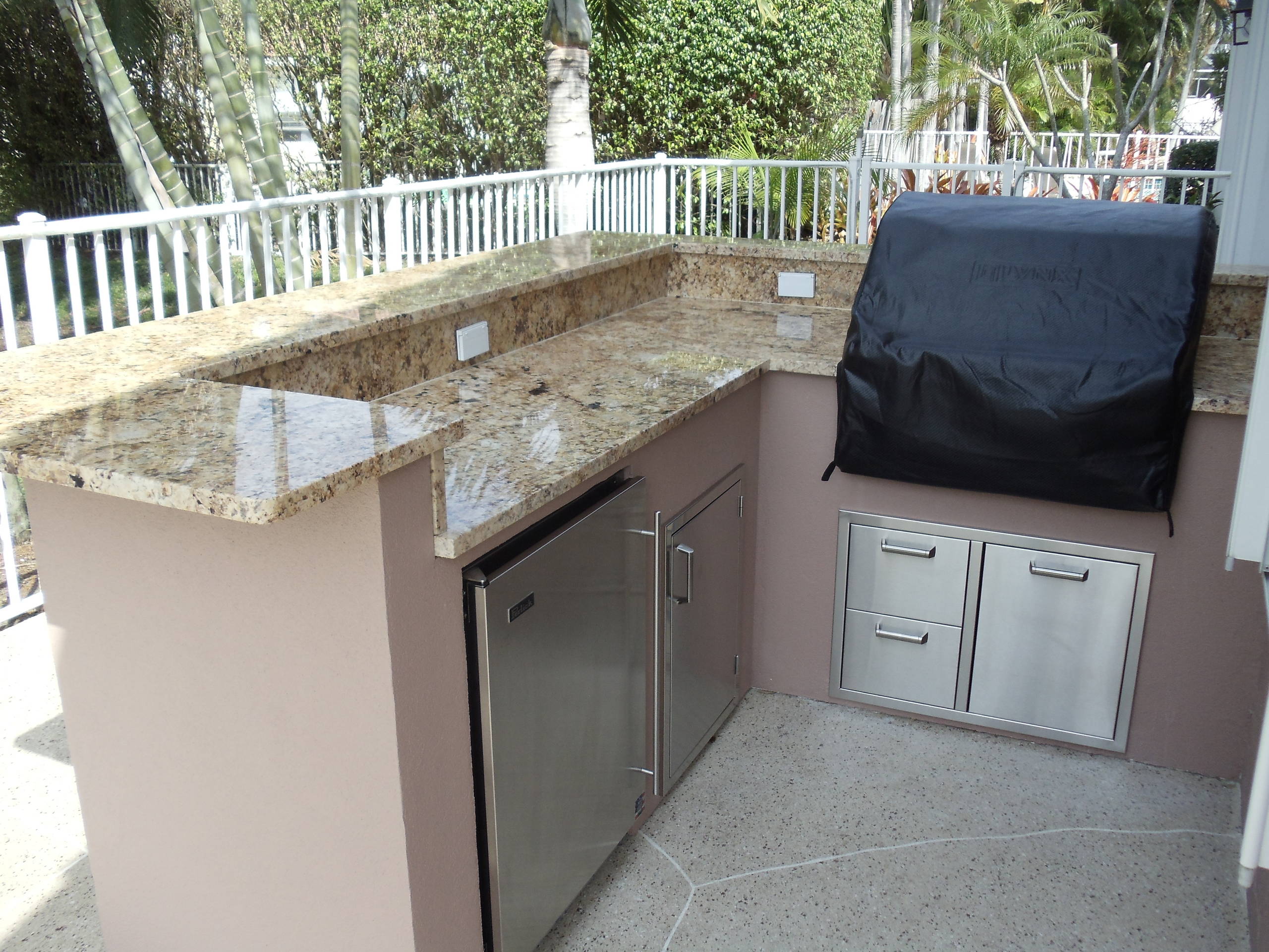 Inspiration for a tropical patio kitchen remodel in Miami with no cover