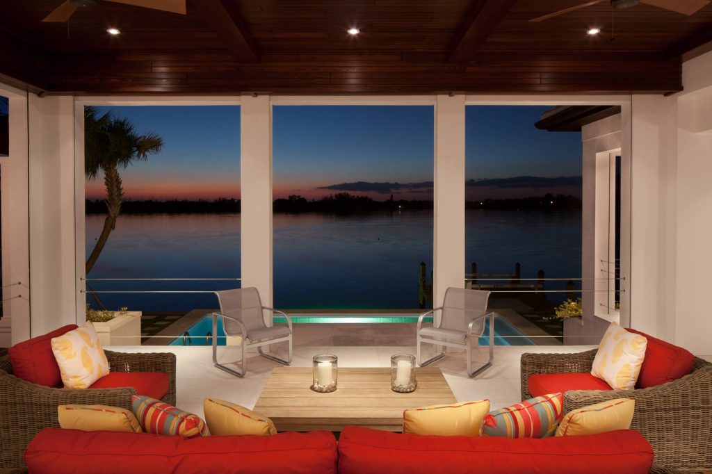 Inspiration for a tropical porch remodel in Tampa with a roof extension by Murray Homes | Outdoor Photos | Porch | Landscaping | Landscape Design | Outdoor Living Space | Porch Design Ideas | Outdoor Living Space Ideas | Backyard Design