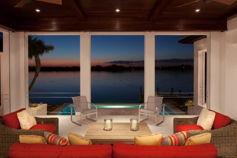 Inspiration for a tropical porch remodel in Tampa with a roof extension by Murray Homes | Outdoor Photos | Porch | Landscaping | Landscape Design | Outdoor Living Space | Porch Design Ideas | Outdoor Living Space Ideas | Backyard Design