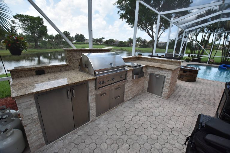 Island style backyard brick patio kitchen photo in Miami with no cover