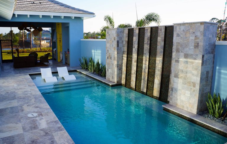 Knaak Design Group This clean lined modern pool with glass tiled water feature makes for a nice relaxing getaway.