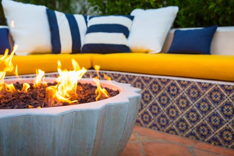 Kornegay pot converted to a fire pit with built-in seating with a Spanish tile veneer.