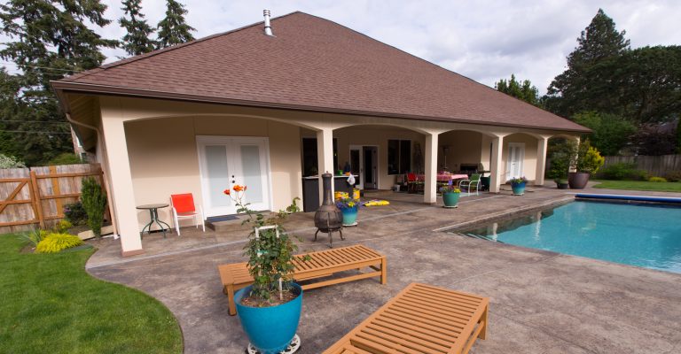 Large arts and crafts backyard concrete patio kitchen photo in Seattle with a roof extension