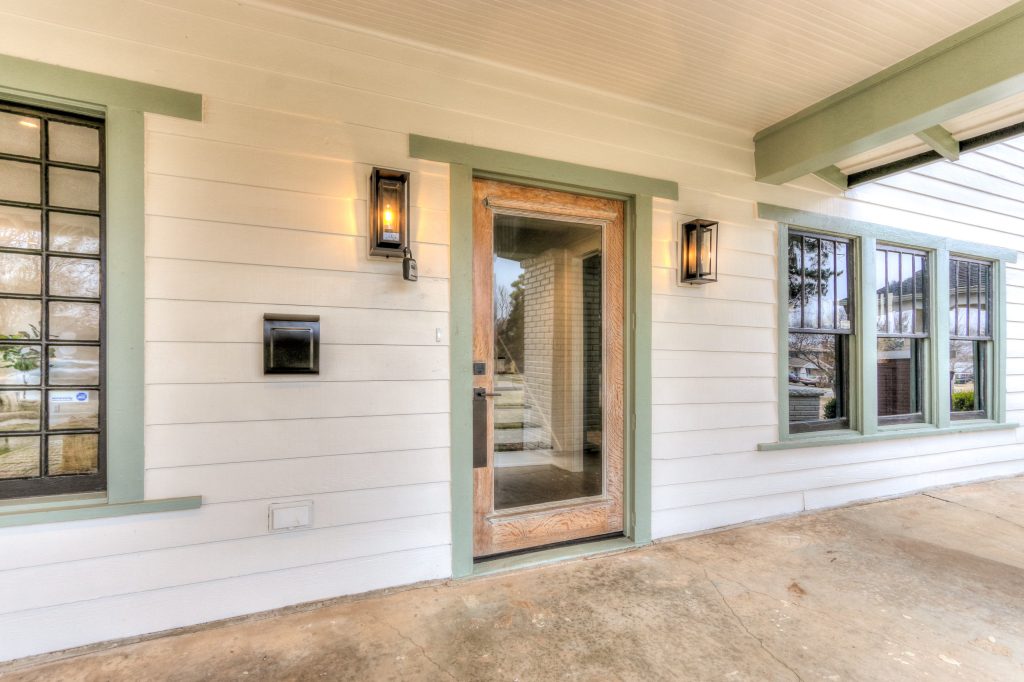 Large arts and crafts concrete front porch photo in Oklahoma City with a roof extension by We3 Dwellings | Outdoor Photos | Porch | Landscaping | Landscape Design | Outdoor Living Space | Porch Design Ideas | Outdoor Living Space Ideas | Backyard Design