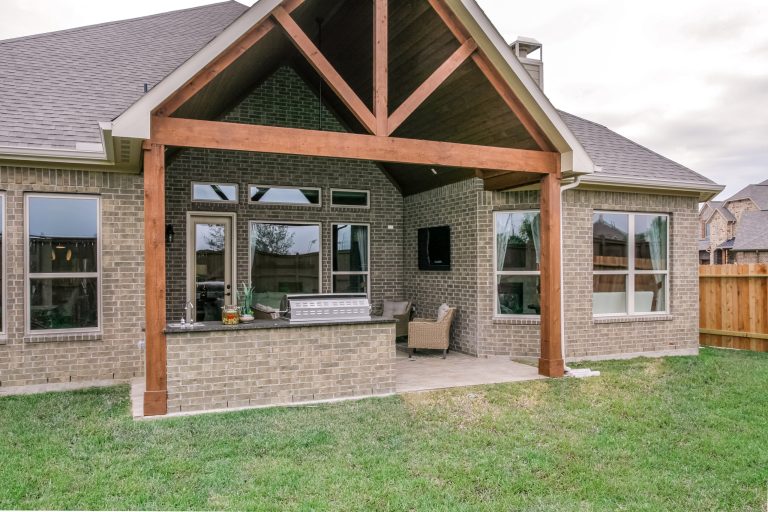 Large backyard tile patio kitchen photo in Austin with a roof extension