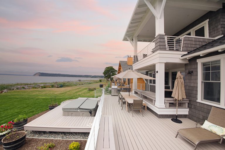 Large beach style backyard outdoor kitchen deck photo in Seattle with no cover