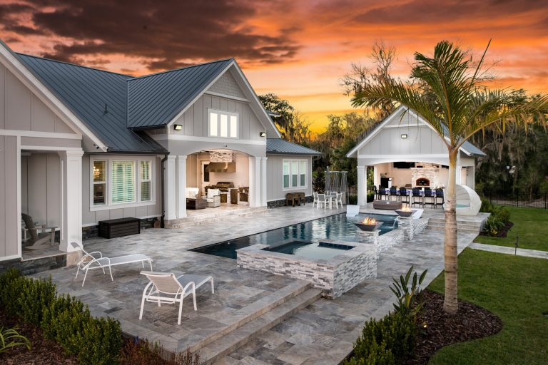 Large beach style backyard stone and rectangular natural pool house photo in Tampa