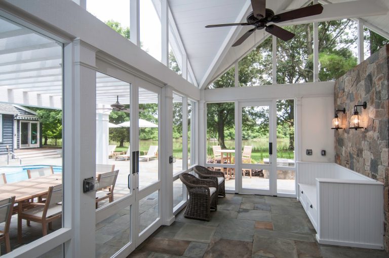 Large beach style stone screened-in back porch photo in DC Metro with a roof extension by McHale Landscape Design, Inc. | Outdoor Photos | Porch | Landscaping | Landscape Design | Outdoor Living Space | Porch Design Ideas | Outdoor Living Space Ideas | Backyard Design