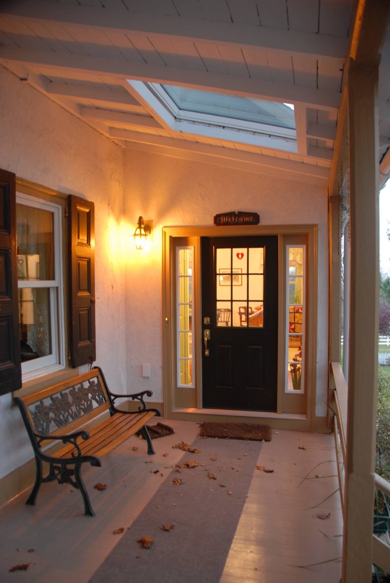 Large brick side porch photo in Philadelphia with a roof extension by James A. Turner Company | Outdoor Photos | Porch | Landscaping | Landscape Design | Outdoor Living Space | Porch Design Ideas | Outdoor Living Space Ideas | Backyard Design