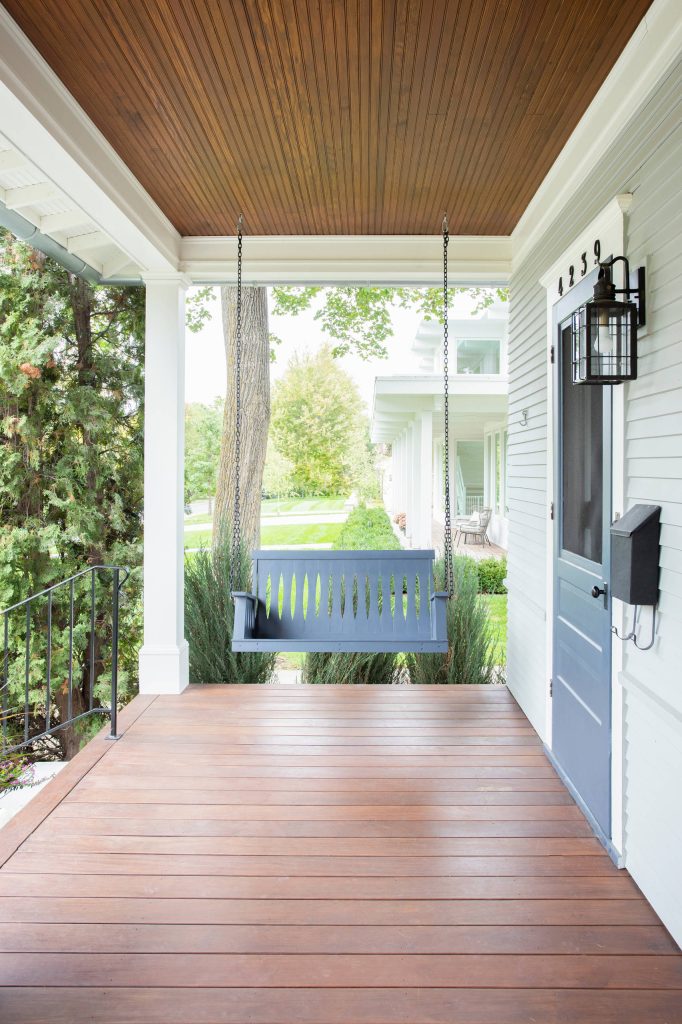 Large classic front porch idea in Minneapolis with decking and a roof extension by TreHus Architects+Interior Designers+Builders | Outdoor Photos | Porch | Landscaping | Landscape Design | Outdoor Living Space | Porch Design Ideas | Outdoor Living Space Ideas | Backyard Design