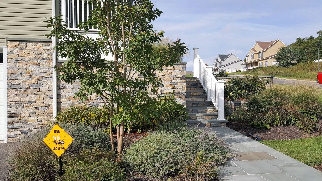 Large classic stone front porch idea in New York with a roof extension by Castro StoneWorks NY - Masonry Contractors | Outdoor Photos | Porch | Landscaping | Landscape Design | Outdoor Living Space | Porch Design Ideas | Outdoor Living Space Ideas | Backyard Design