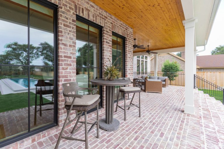 Large cottage brick back porch idea in Houston with a roof extension by Stone Acorn Builders | Outdoor Photos | Porch | Landscaping | Landscape Design | Outdoor Living Space | Porch Design Ideas | Outdoor Living Space Ideas | Backyard Design