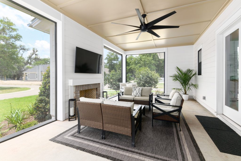 Large cottage concrete back porch idea in Jacksonville with a fireplace and a roof extension by John Merrill Homes, LLC | Outdoor Photos | Porch | Landscaping | Landscape Design | Outdoor Living Space | Porch Design Ideas | Outdoor Living Space Ideas | Backyard Design