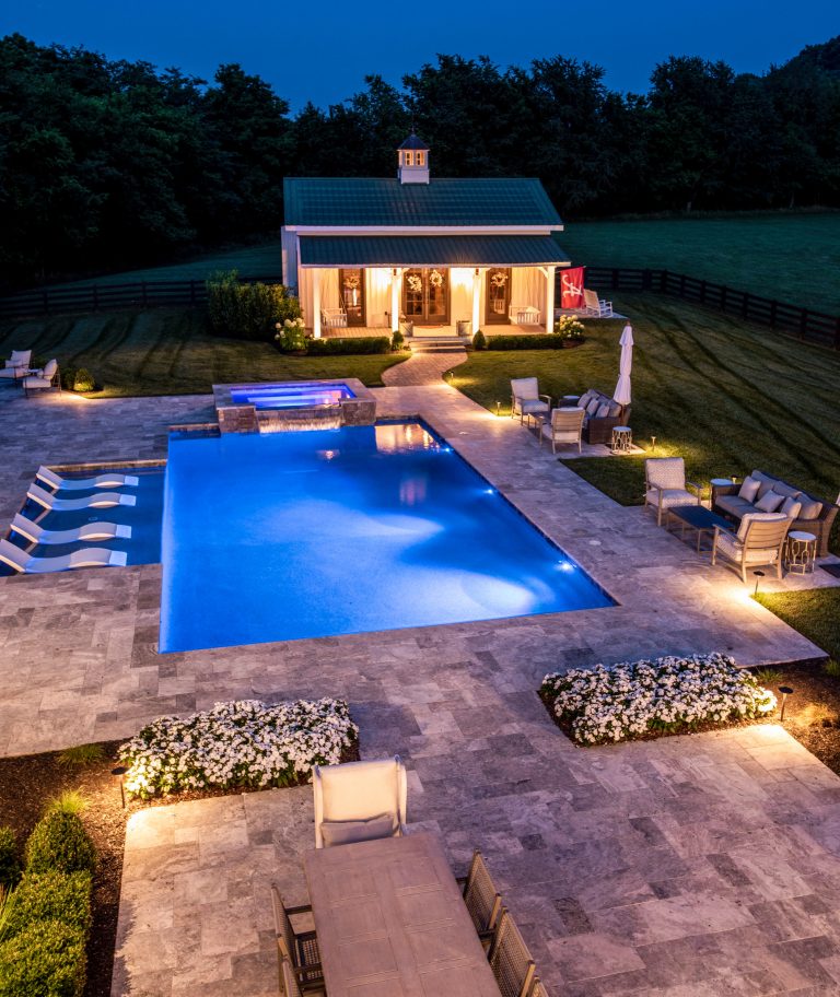 Large country backyard stone and custom-shaped pool photo in Nashville