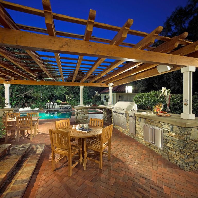 Large eclectic backyard brick patio kitchen photo in Los Angeles with a pergola