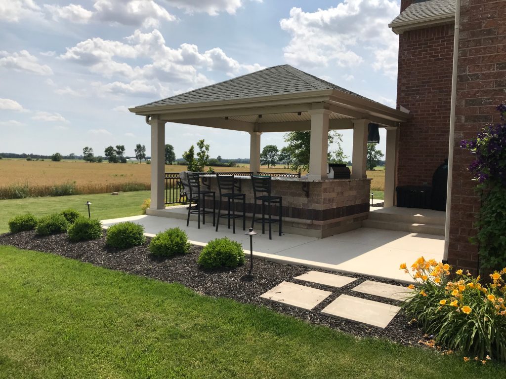 Large elegant backyard concrete patio kitchen photo in Other with a gazebo