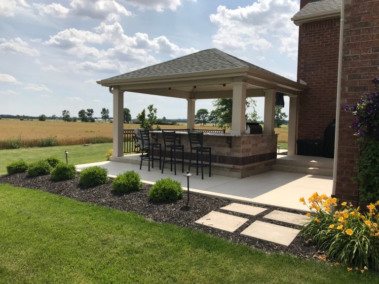 Large elegant backyard concrete patio kitchen photo in Other with a gazebo