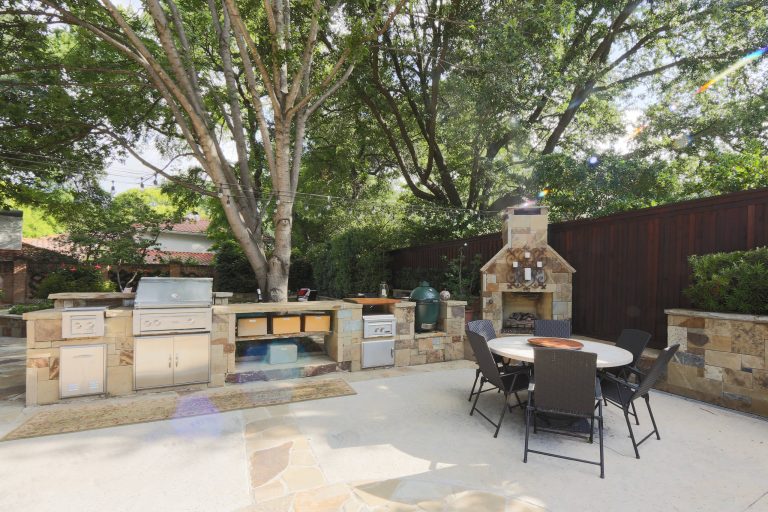 Large elegant backyard concrete patio kitchen photo with no cover