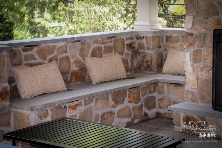 Large elegant backyard concrete paver patio kitchen photo in Other with a gazebo