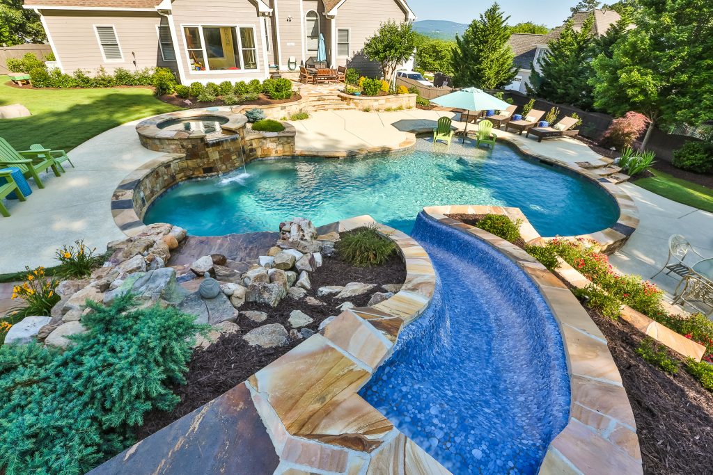 Large elegant backyard custom-shaped and concrete natural water slide photo in Atlanta