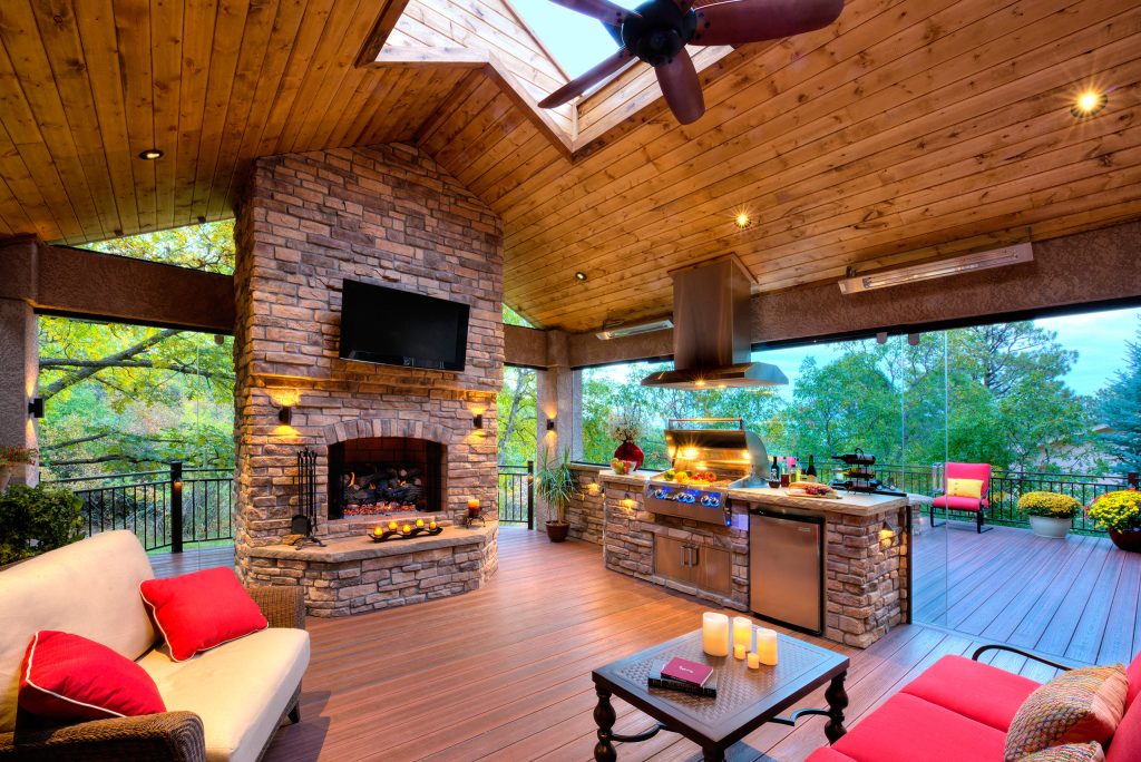 Large elegant backyard outdoor kitchen deck photo in Los Angeles with a pergola