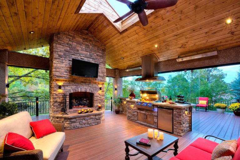 Large elegant backyard outdoor kitchen deck photo in Los Angeles with a pergola