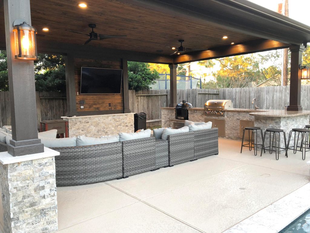 Large elegant backyard stamped concrete patio kitchen photo in Houston with a gazebo