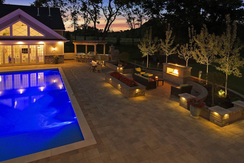Large elegant backyard stone and rectangular lap pool photo in Minneapolis