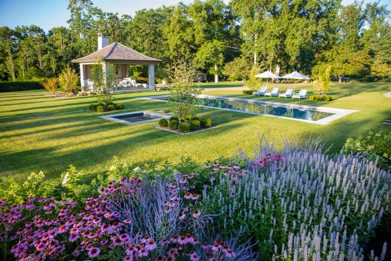 Large elegant backyard stone and rectangular pool house photo in New York