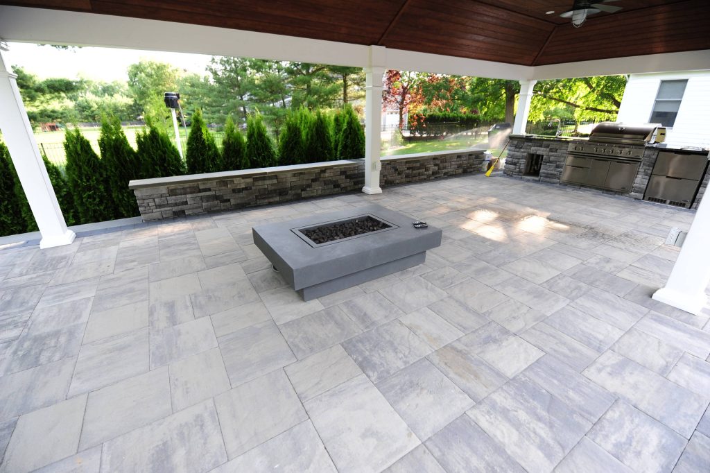 Large elegant backyard stone patio kitchen photo in Philadelphia with a gazebo