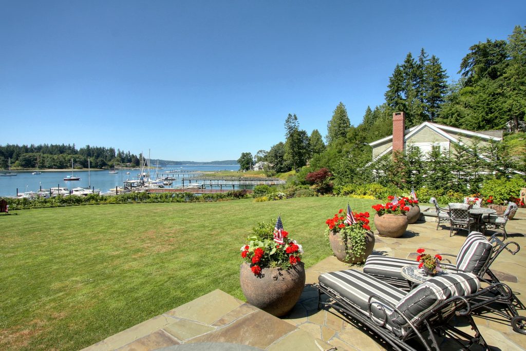 Large elegant backyard stone patio kitchen photo in Seattle with a roof extension