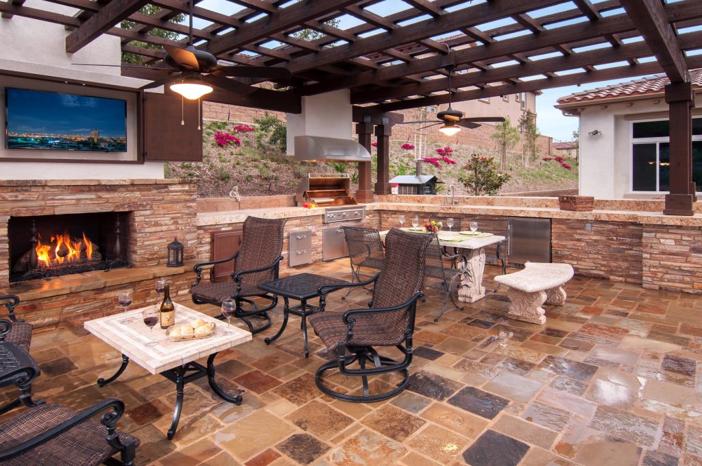 Large elegant backyard tile patio kitchen photo in Orange County with a gazebo