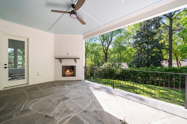 Large elegant brick back porch photo in Raleigh with a fireplace and a roof extension by Cambridge Classic Homes | Outdoor Photos | Porch | Landscaping | Landscape Design | Outdoor Living Space | Porch Design Ideas | Outdoor Living Space Ideas | Backyard Design