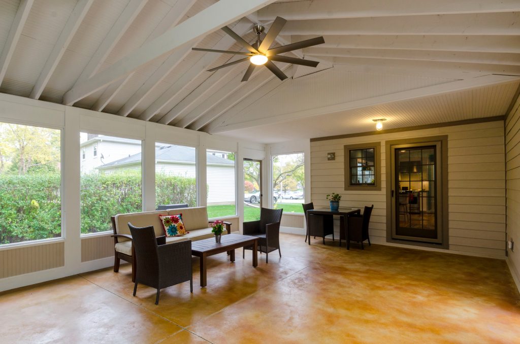 Large elegant concrete screened-in back porch photo in Chicago with a roof extension by Synergy Builders Inc. | Outdoor Photos | Porch | Landscaping | Landscape Design | Outdoor Living Space | Porch Design Ideas | Outdoor Living Space Ideas | Backyard Design