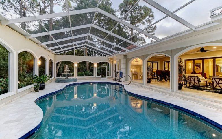 Large elegant indoor stone and custom-shaped lap pool fountain photo in Tampa