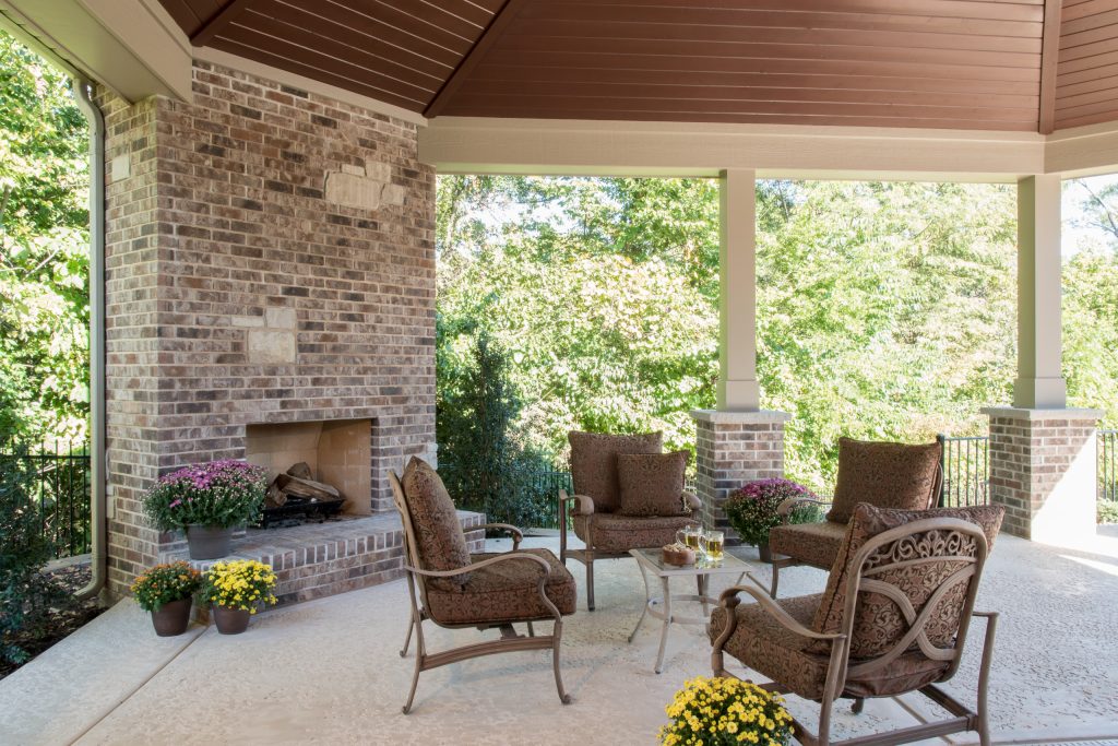 Large elegant stamped concrete porch photo in St Louis with a roof extension