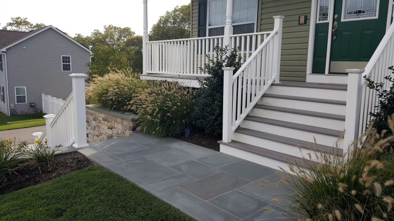 Large elegant stone front porch photo in New York with a roof extension by Castro StoneWorks NY - Masonry Contractors | Outdoor Photos | Porch | Landscaping | Landscape Design | Outdoor Living Space | Porch Design Ideas | Outdoor Living Space Ideas | Backyard Design