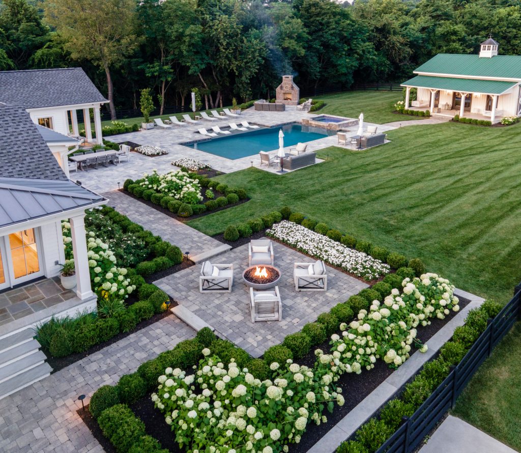Large farmhouse backyard stone and custom-shaped pool photo in Nashville