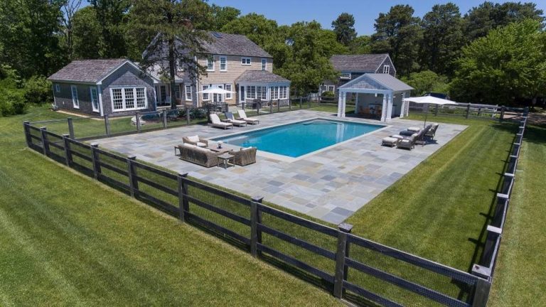 Large farmhouse backyard stone and rectangular lap pool photo in Boston
